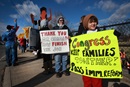 demonstration-immigration-1 Chavin Medina, 8, traveled 165 miles with his mother, Alysa Medina, to show support for immigration reform. In the background is Mary Hutchings and others gathering in solidarity for racial justice on the afternoon that President Obama speaks on immigration in Nashville, Tennessee.
