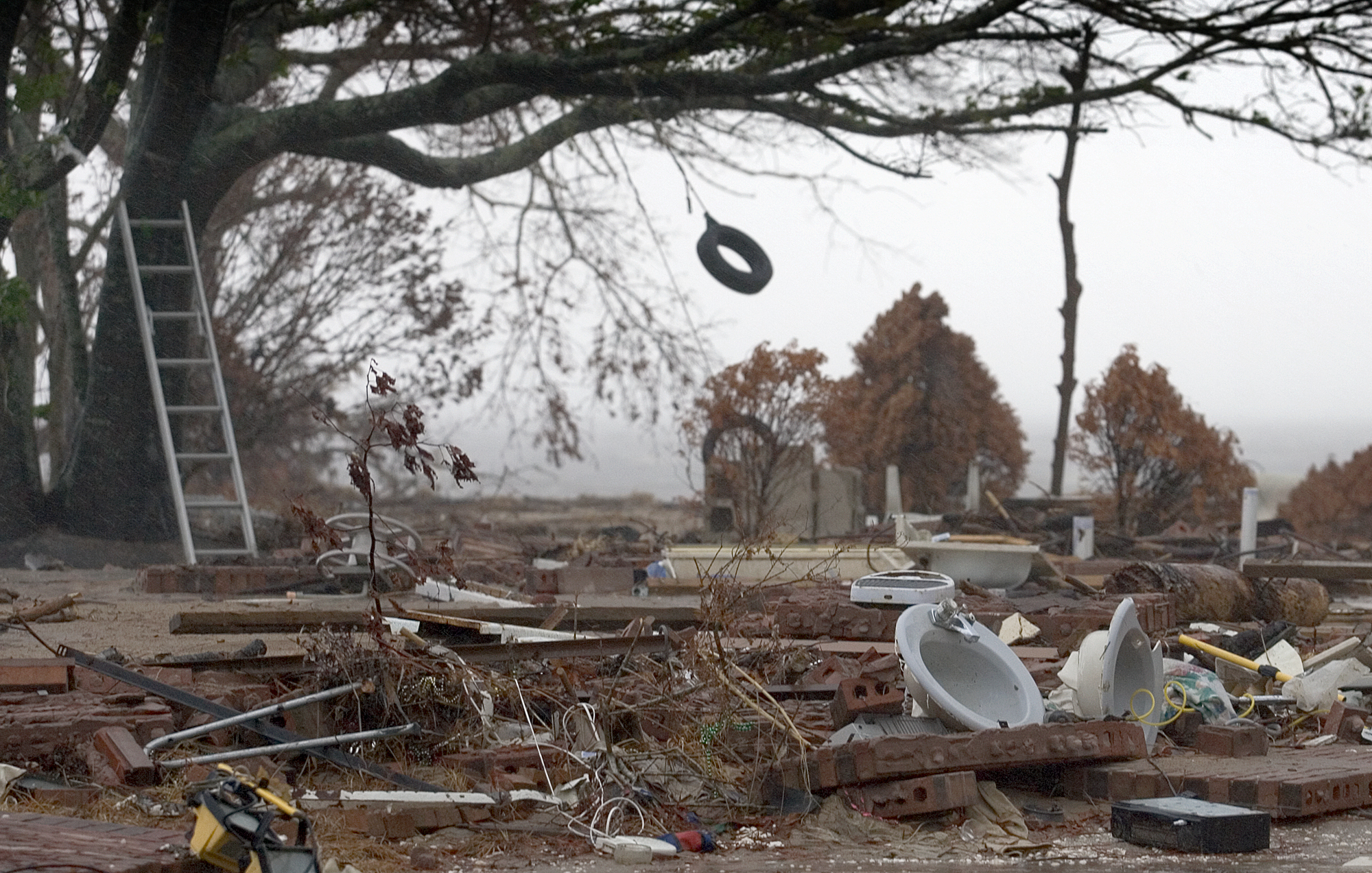 A tire swing sways in the wind from Hurricane Rita over the remains of a beachfront home destroyed by Hurricane Katrina in Ocean Springs, Miss. Rita made landfall in East Texas Sept. 24, 2005, nearly four weeks after Katrina hit Louisiana and Mississippi. Photo by Mike DuBose, UMNS.