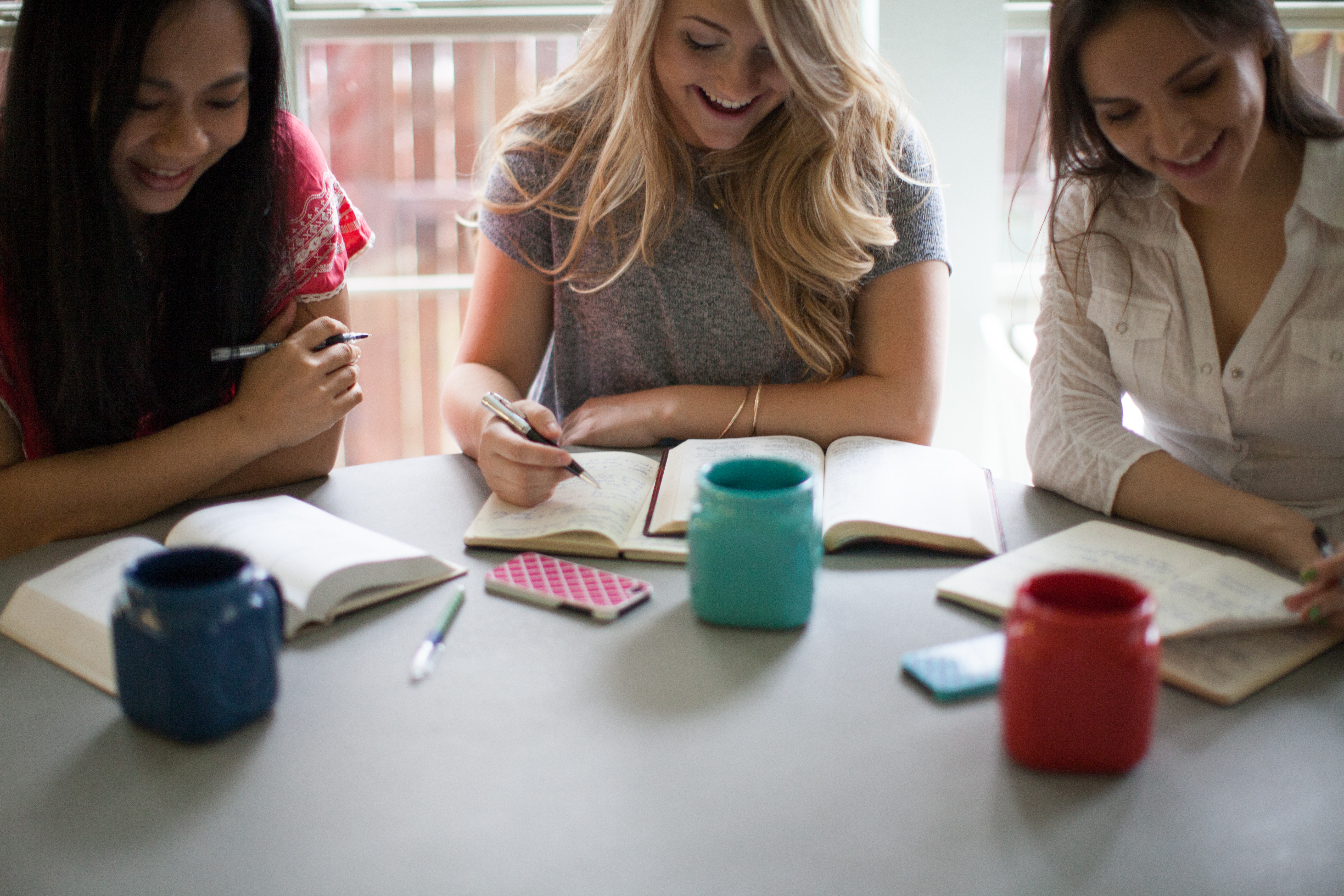 Young women participate in a Bible study group. Photo by Pearl, Lightstock.com.