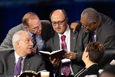 Bishops confer over the issue of whether the legislative committee can refer items to the denomination's Judicial Council for review during the 2019 United Methodist General Conference in St. Louis. Clockwise from lower left are Bishops Thomas Bickerton, John Schol, David Bard, Julius C. Trimble and Cynthia Fierro Harvey. Photo by Mike DuBose, UMNS.