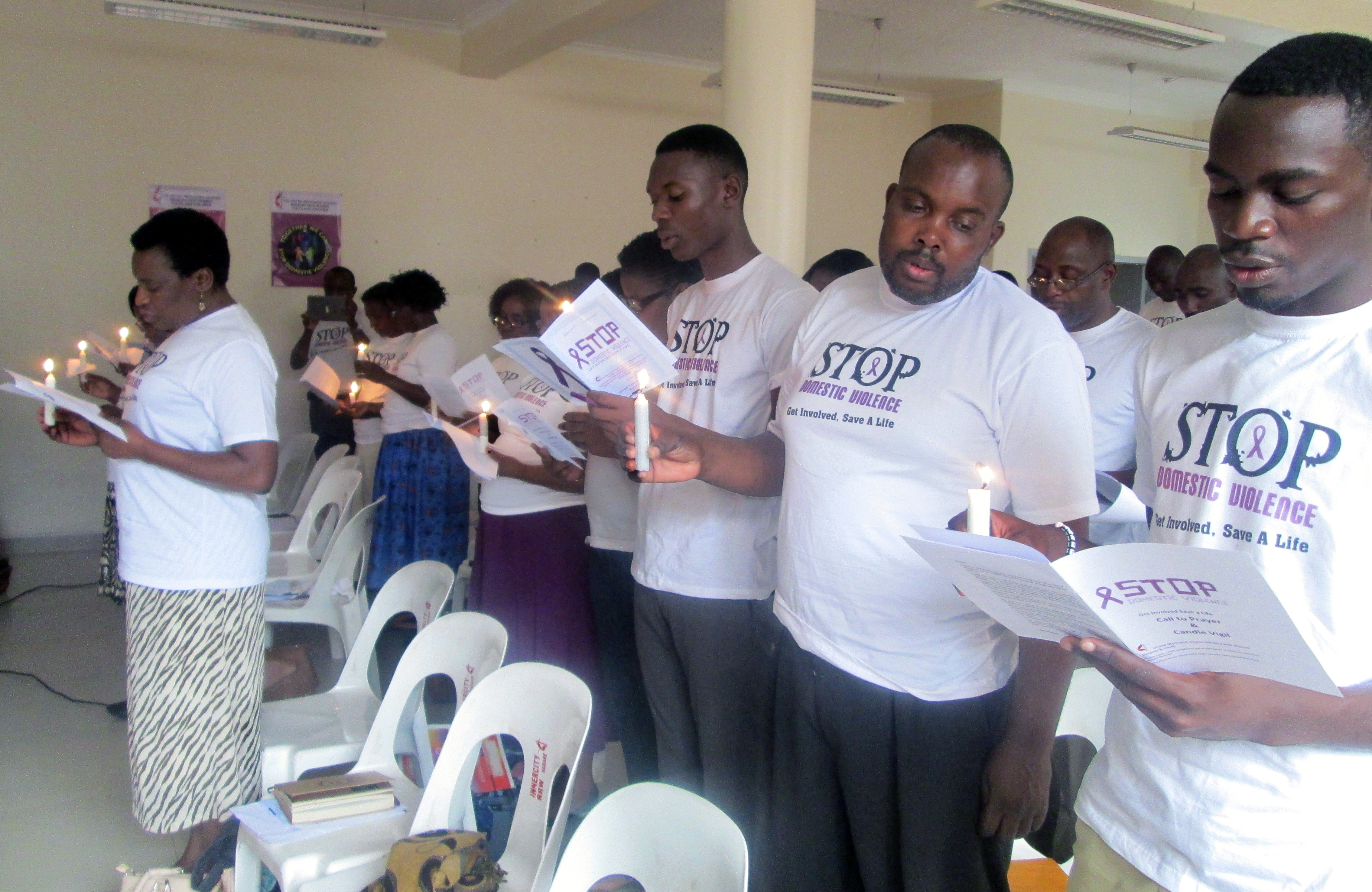Participants at a United Methodist workshop on domestic violence hold a candlelight vigil in memory of victims and survivors. Photo by Eveline Chikwanah