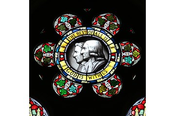 A stained-glass window featuring John and Charles Wesley is found at the Wesley Memorial Methodist Church in Epworth, England. Photo by Kathleen Barry, United Methodist Communications
