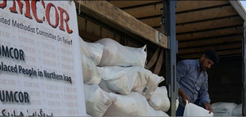 Man delivering food supplies for UMCOR.