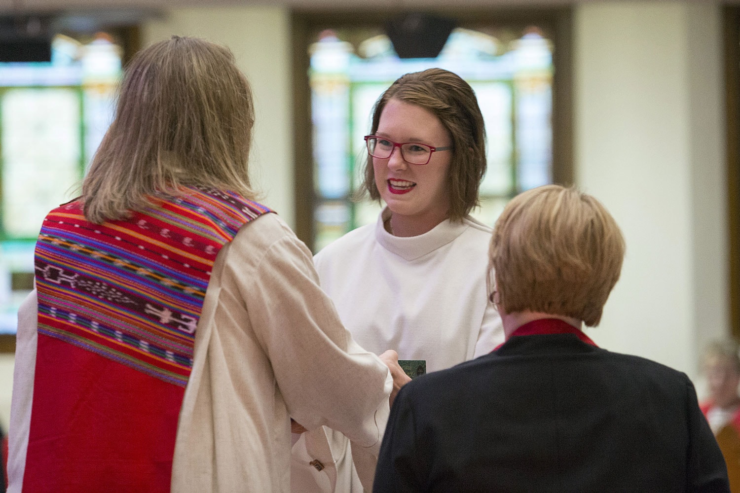 A pastor recognizes members for their service to the community. 