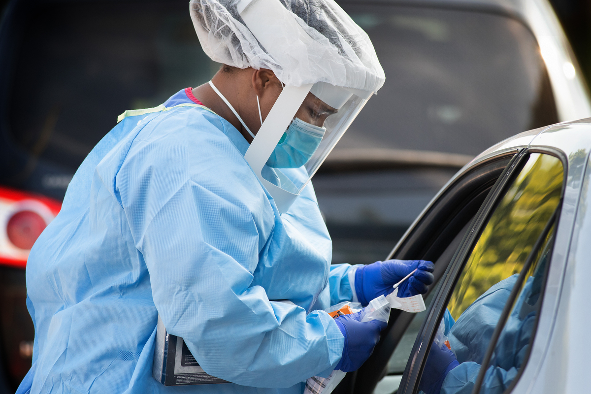 Dr. Antoinette Williams secures a sample swab from a patient at a drive-thru testing site for COVID-19 at St. Luke Christian Methodist Episcopal Church in Nashville, Tenn. Williams is a resident at Meharry Medical College in Nashville. Volunteer teams from the United Methodist-related school have been offering free testing at area churches on Saturdays. Photo by Mike DuBose, UM News.