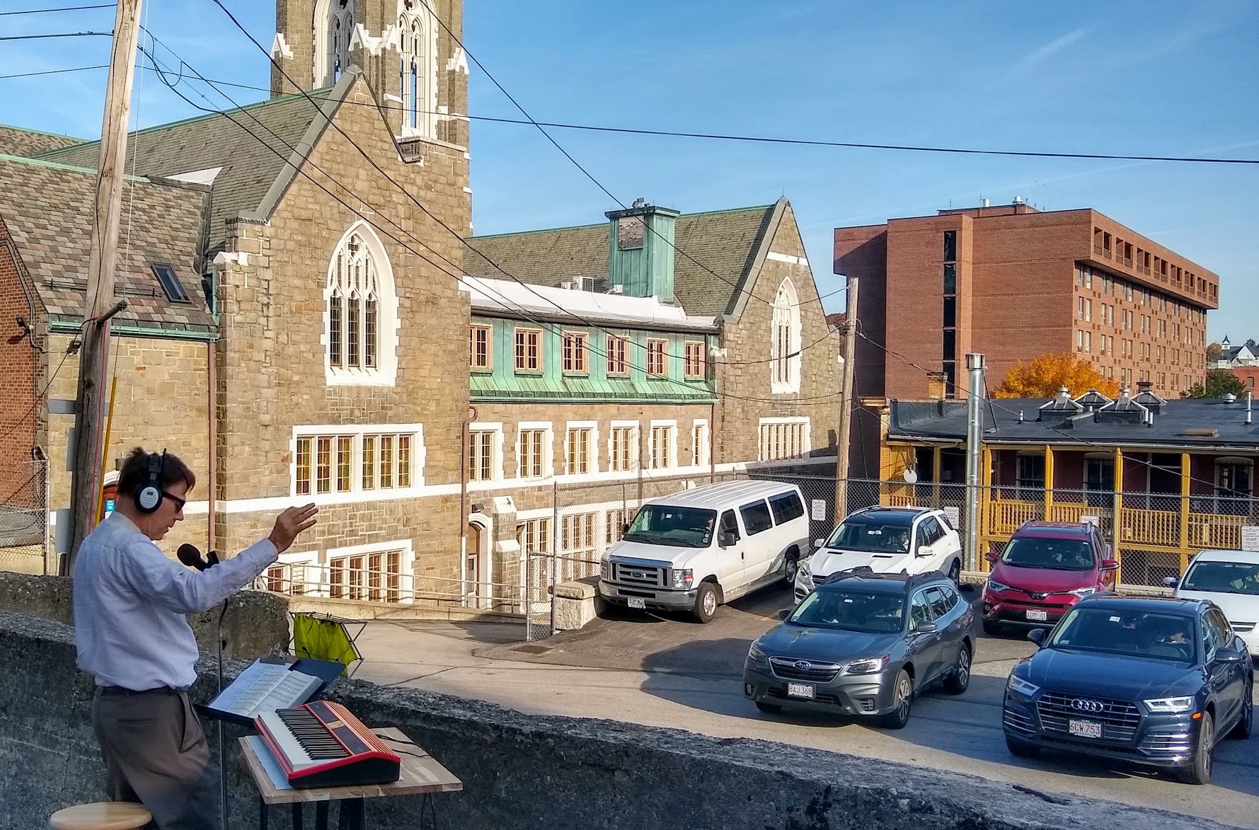 Wesley UMC music director William Ness directs parking lot choir. Photo courtesy of Nan Gibbons.