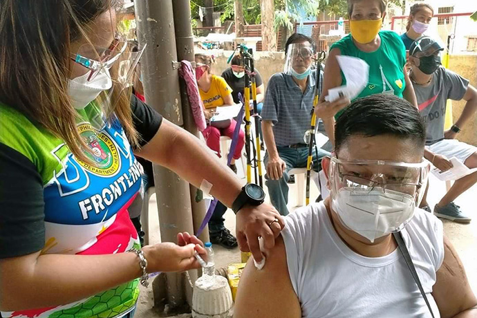 The Rev. Marvin Sulayao De Leon of Manena United Methodist Church in Bulacan, Philippines, receives a COVID-19 vaccine at San Miguel Bulacan Vaccination Center. United Methodists in the Philippines have worked with the government to fast-track vaccinations for church leaders, who are not categorized as front line workers, so that their ministry with the community can continue safely. Photo courtesy of  Glessie Yambot De Leon.