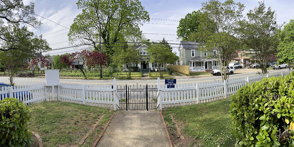 Missionary Julie Wilson tracks the progress of gentrification in her Winston-Salem neighborhood by looking out the front door. The community members Open Arms serves are increasingly losing their rental homes to people who can purchase and rebuild them. The view from the porch of Open Arms Community center in Winston-Salem, NC, shows three recently purchased homes undergoing renovations. Photo: Julie Wilson.