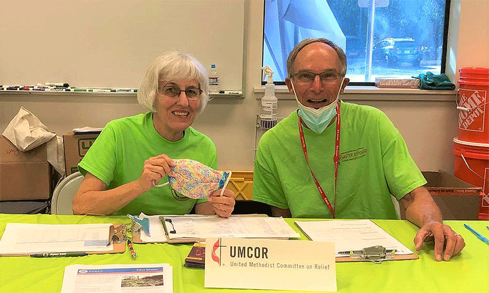 Volunteers Susan Nunn and Steve Elliott, CDRC for Cal-Nev Conference, at an UMCOR California-Nevada table offering supplies, kits, referrals and other resources to fire survivors. (Photo: California-Nevada Conference)