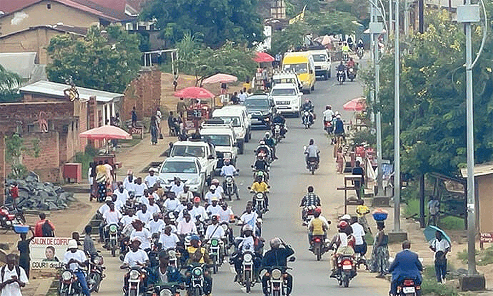 A caravan using loudspeakers to broadcast a call for peaceful elections makes its way through Kibombo, Congo. Photo by Chadrack Tambwe Londe, UM News.