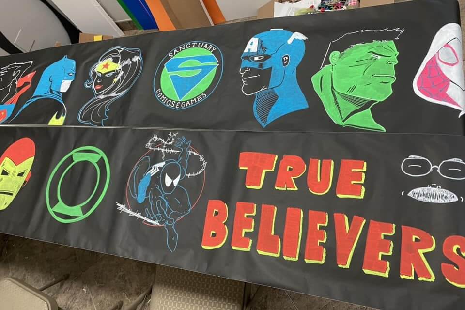 Banner for Sanctuary Comics and Games, and outreach ministry of Village UMC