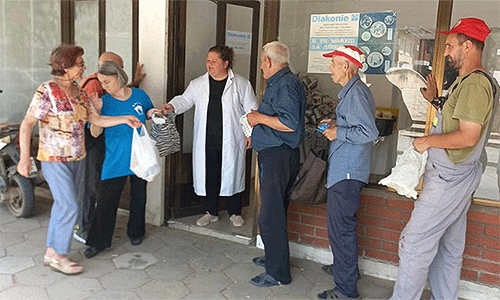 Photo: People in Radovish wait for their daily warm meal.