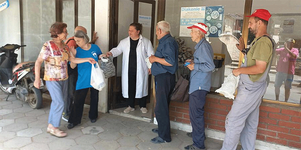 Photo: People in Radovish wait for their daily warm meal.