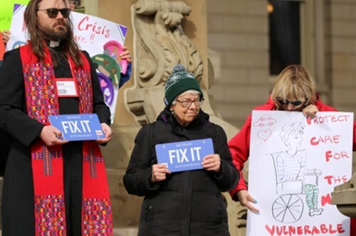 United Methodist clergy and laity stand on the steps of the Michigan State Capitol in Lansing during a press conference and rally for Advocacy Day