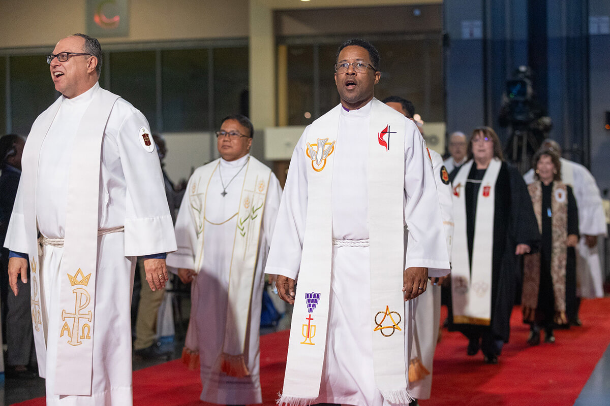 A procession of United Methodist bishops leads opening worship at the 2024 United Methodist General Conference on April 23, 2024, in Charlotte, N.C. The board of The United Methodist Church’s finance agency voted to give bishops a 3% retroactive salary increase. The move comes after bishops in December asked to forgo a raise in 2025 amid tight budgets denomination-wide. File photo by Mike DuBose, UM News.