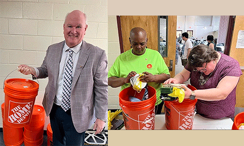 Jim Cox, UMCOR’s Executive Director, holds a finished disaster kit while other volunteers prepare a disaster kit. Courtesy photo.