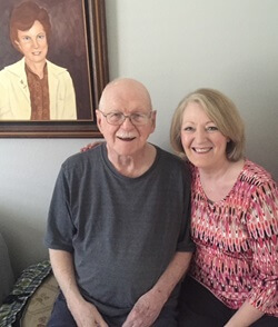 Buchanan visited John Quinlan (left) weekly for years until his death. She reflects, “He taught me much about lifelong learning. He was the most curious individual that I’ve ever known. He took up painting following a stroke, as part of his rehabilitation. The picture on the wall is one that he painted of his late wife.” Photo courtesy of Missy Buchanan.