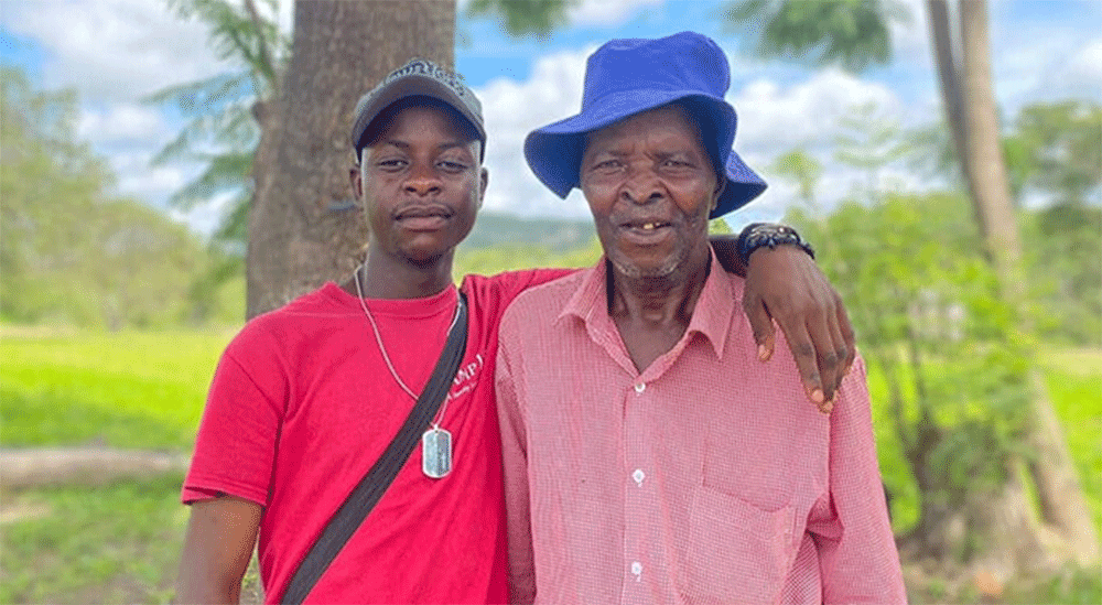 Panashe Banda poses with his uncle, James Chadamoyo Chipuka, at their rural homestead in Chikomo village in the Murewa District of Zimbabwe. Banda received the Bishop’s Episcopal Scholarship, which covered his costs to attend Africa University. “I hope to carry forward the same spirit of generosity and purpose that the church exemplified,” Banda said. Photo by Chenayi Kumuterera, UM News.