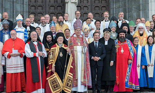 Church leaders from around the globe accompanied by Swedish Prime Minister Ulf Kristersson and his wife Rev. Birgitta Ed, pose for a group photo following an ecumenical prayer service in Uppsala Cathedral.  Photo:  Albin Hillert/WCC 